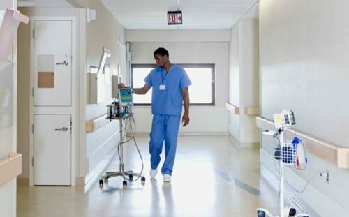 Medical staff in a hospital corridor - temperature monitoring