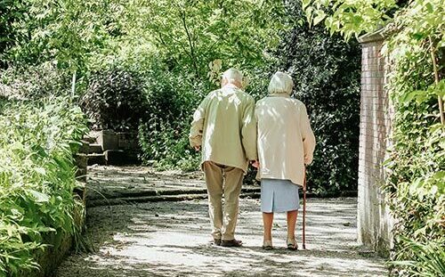 Two elderly people walking