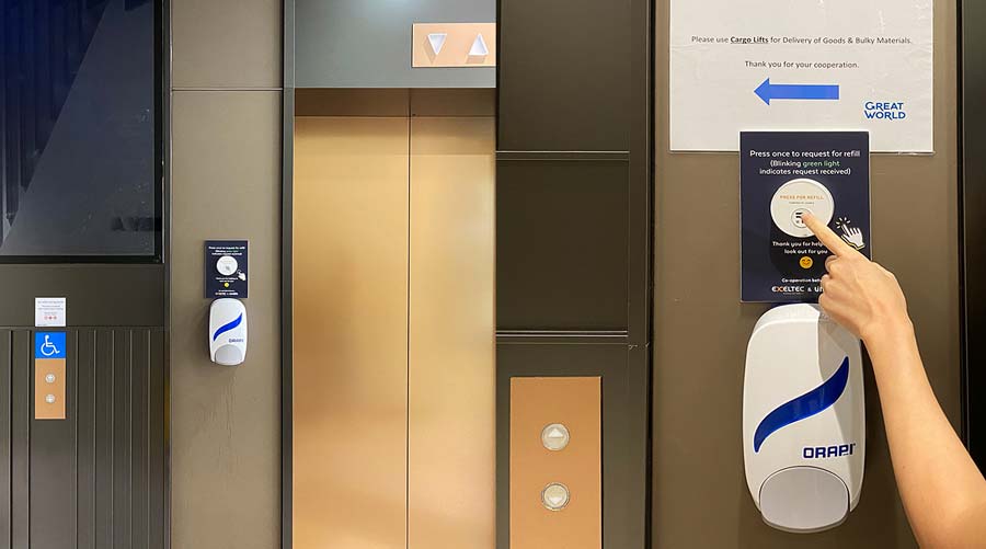 unabell smart button for hand sanitizer dispenser refill, next to an elevator